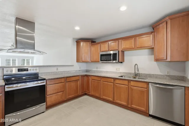 a kitchen with stainless steel appliances a refrigerator and a stove