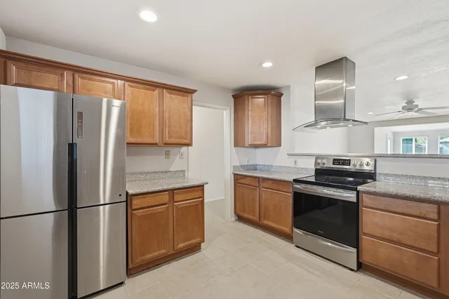 a kitchen with stainless steel appliances granite countertop a sink stove and microwave