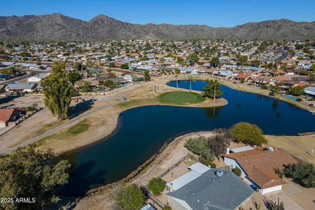 a view of a patio with table and chairs with wooden floor and fence
