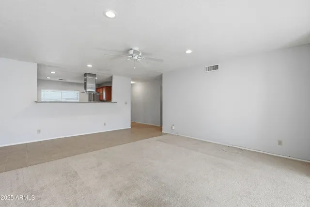an empty room with a kitchen and a sink
