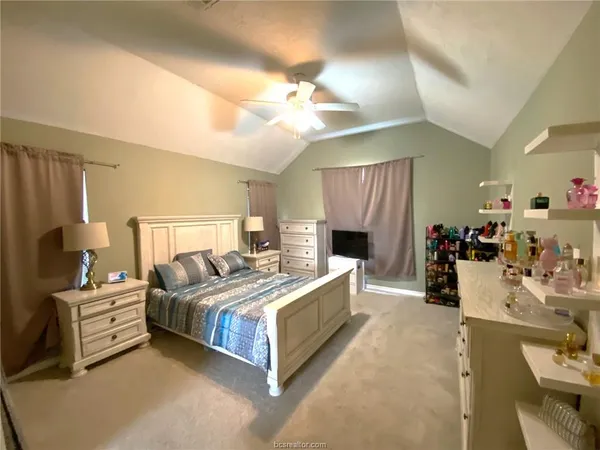 a bed room with a bed and a television