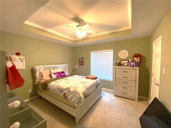 a bedroom with a bed and dresser