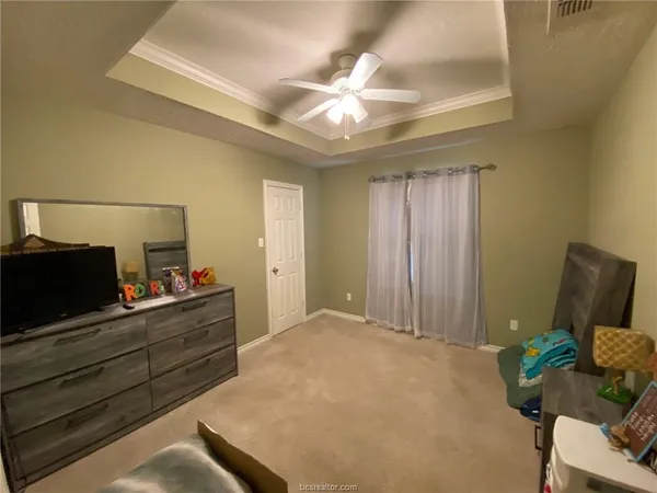 a bed room with furniture and a mirror