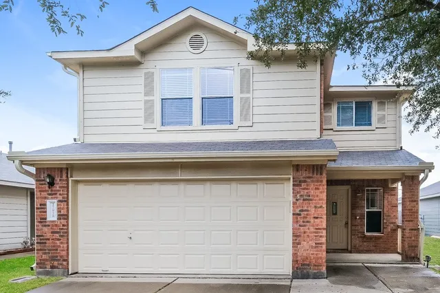 a front view of a house with garage