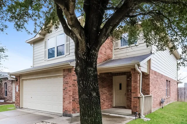 front view of a house with a tree