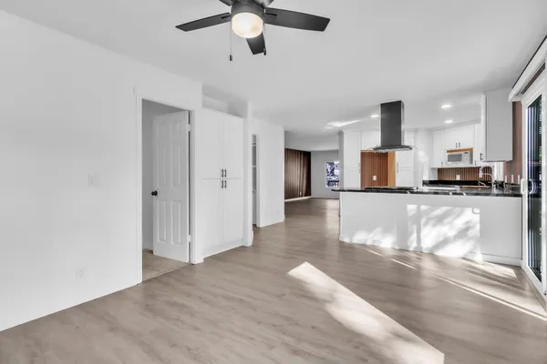 a view of kitchen with cabinets and wooden floor