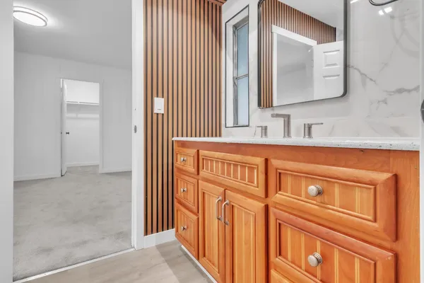 a bathroom with a sink a vanity and a mirror