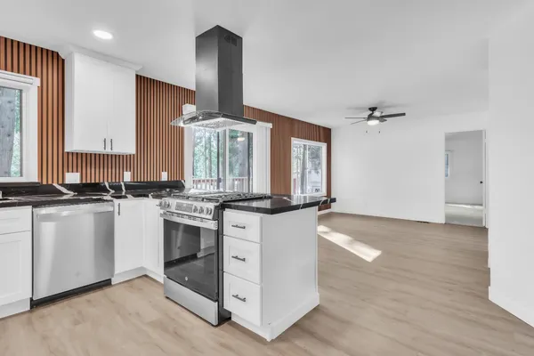 a kitchen with stainless steel appliances granite countertop a stove and a sink