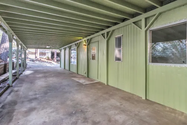 a view of a porch with wooden floor and stairs