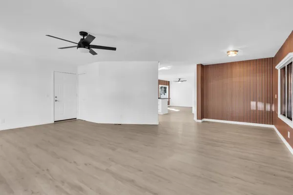 a view of empty room with wooden floor