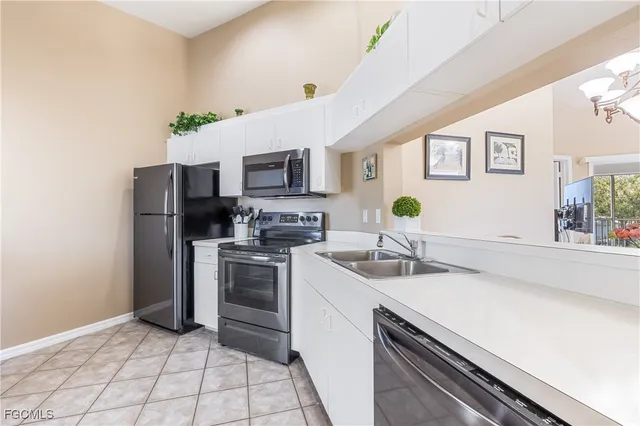a kitchen with a sink appliances and cabinets