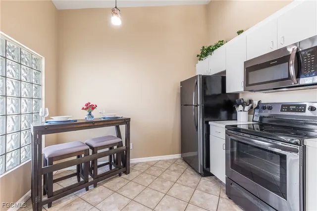 a kitchen with stainless steel appliances a stove microwave and refrigerator