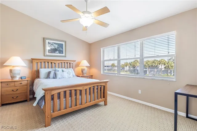 a bedroom with a bed chandelier and a window