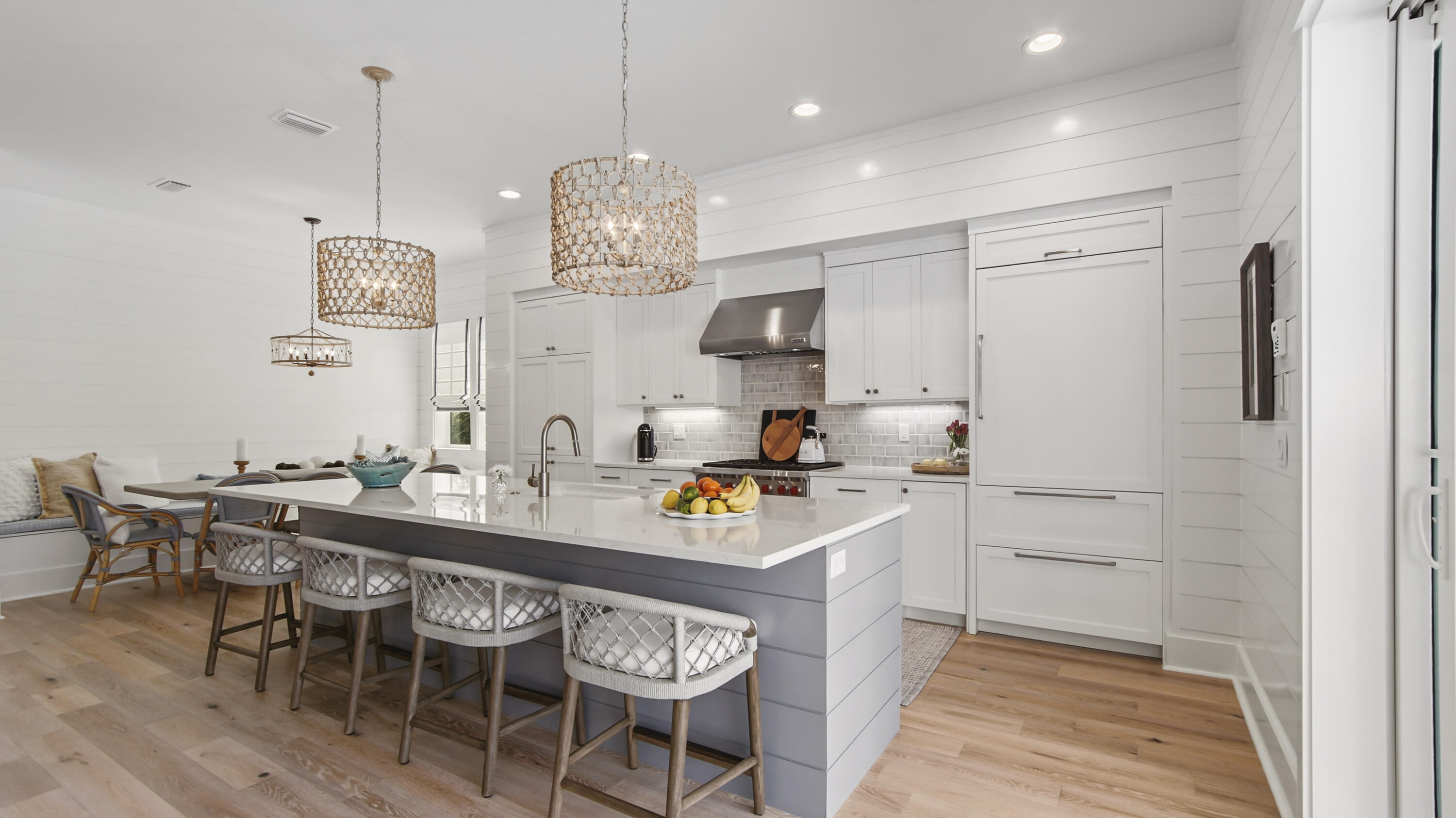 34 Heartwood Street Watersound, FL 32461 - Photo 6 of 42 a kitchen with a dining table cabinets and stainless steel appliances