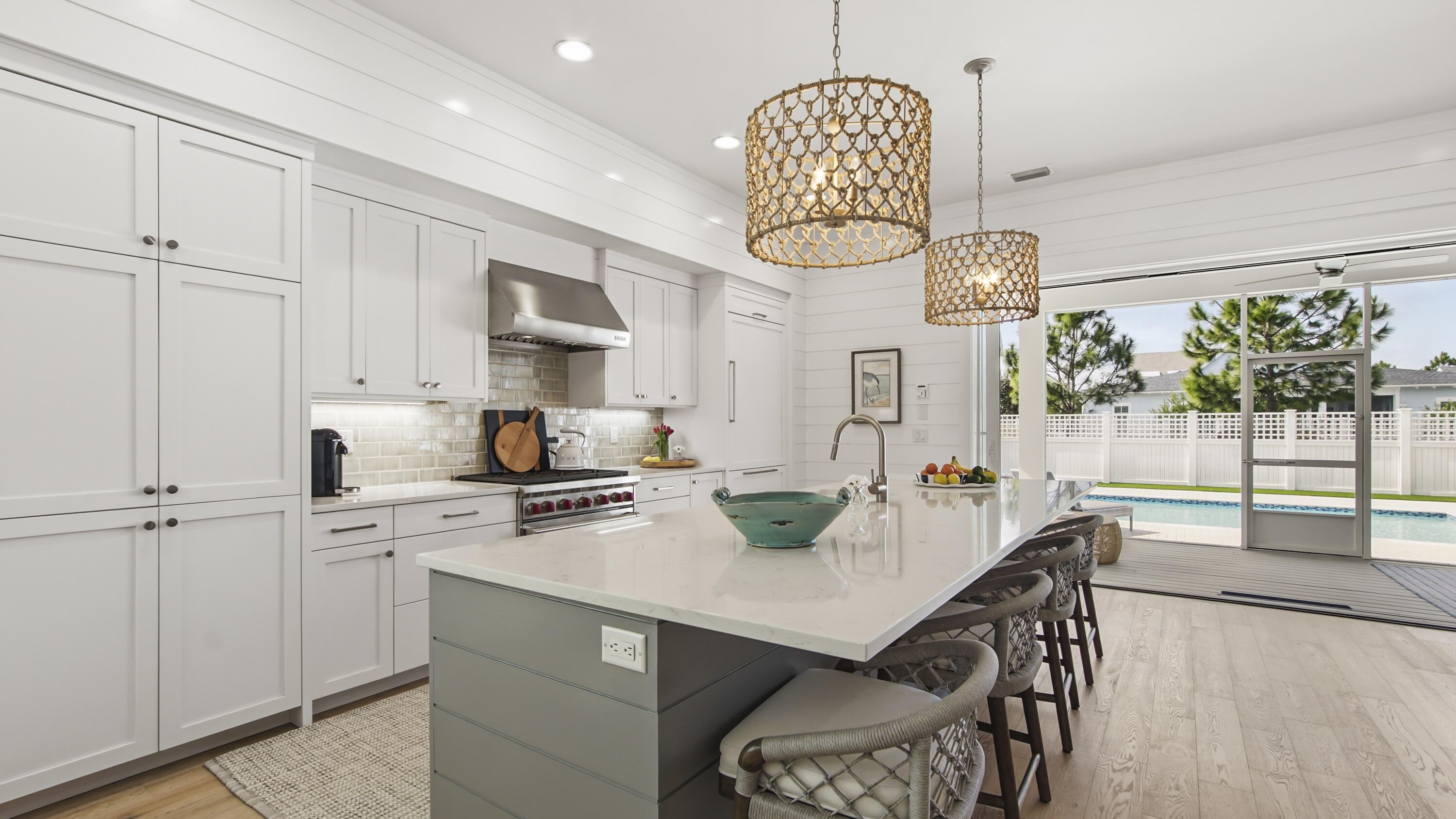 34 Heartwood Street Watersound, FL 32461 - Photo 10 of 42 a kitchen with a table chairs and white cabinets