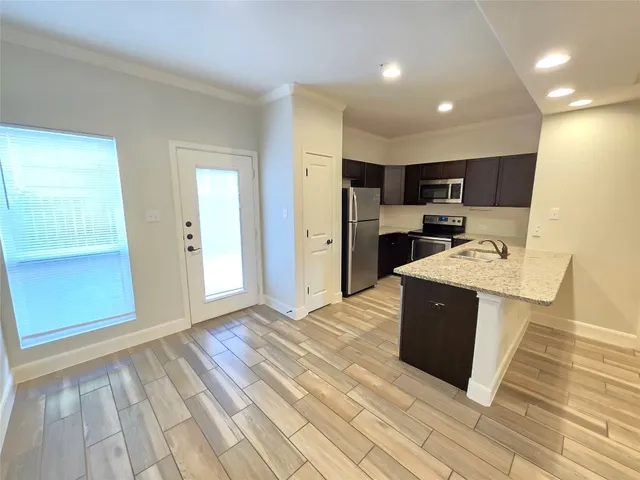 a view of kitchen with refrigerator microwave and stove