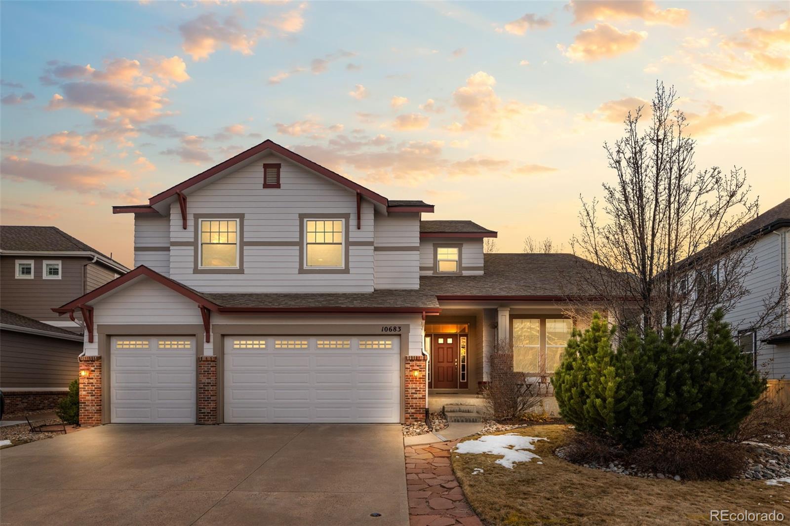 10683 Amesbury Way Highlands Ranch, CO 80126 - Photo 1 of 44 a front view of a house with garden