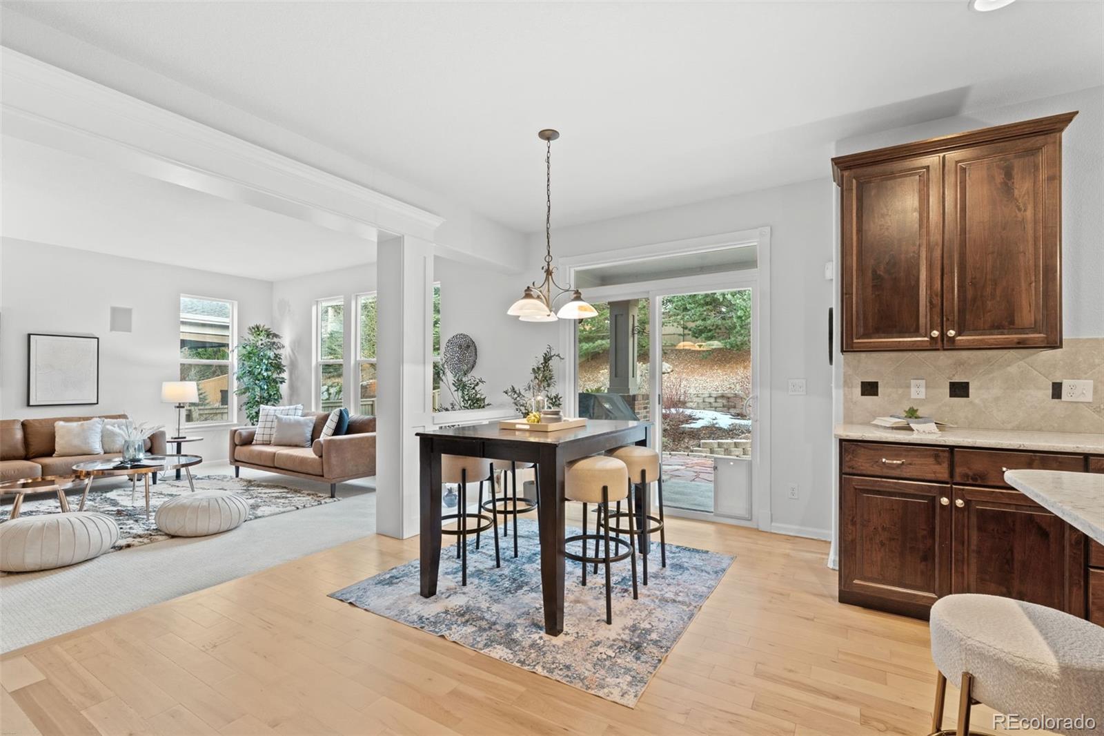 10683 Amesbury Way Highlands Ranch, CO 80126 - Photo 16 of 44 a view of a dining room with furniture window and wooden floor