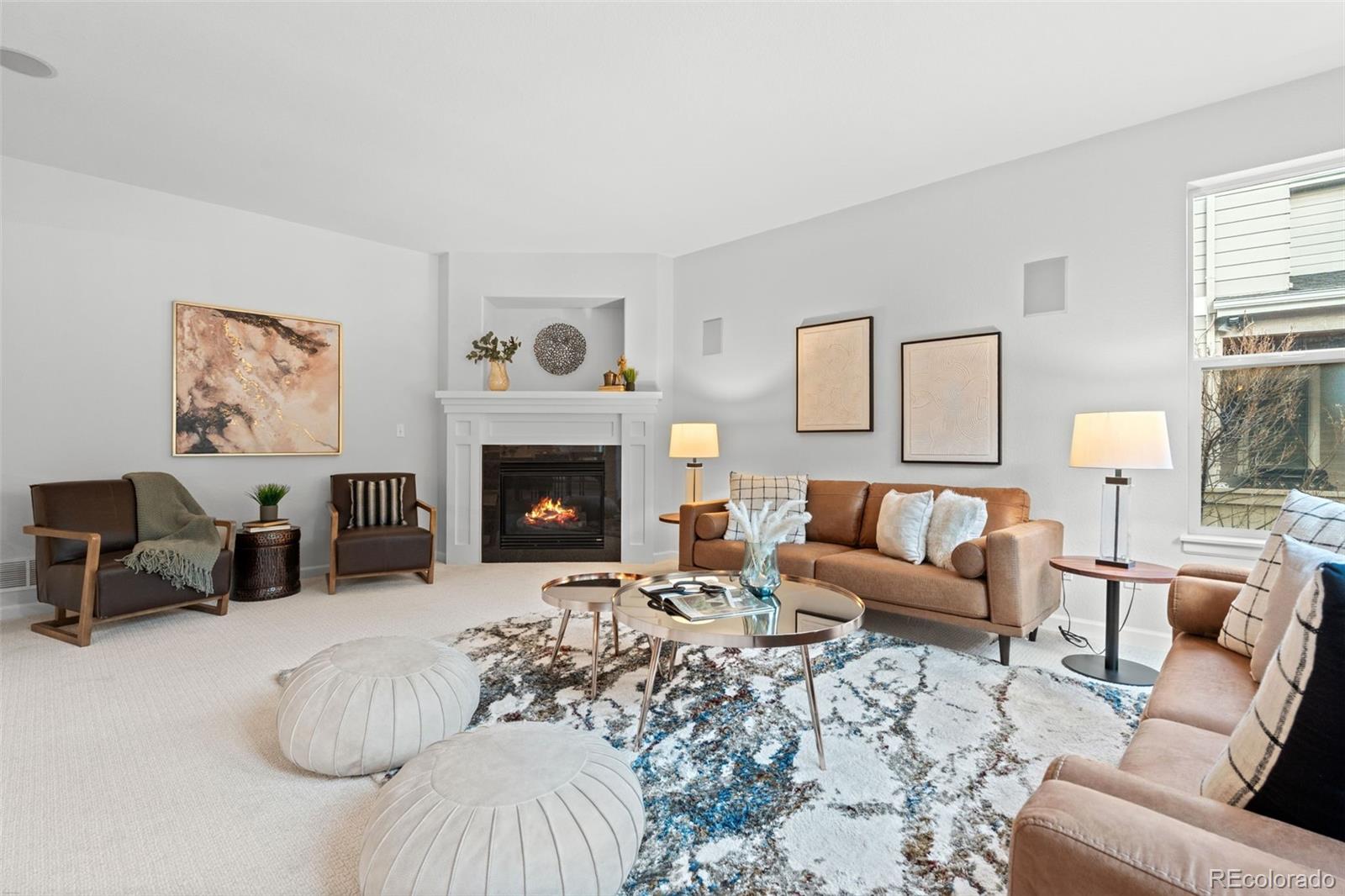 10683 Amesbury Way Highlands Ranch, CO 80126 - Photo 17 of 44 a living room with furniture and a fireplace