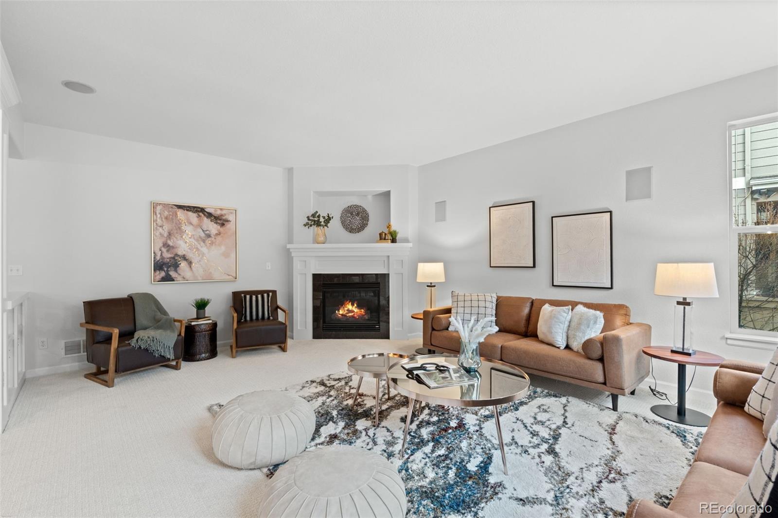 10683 Amesbury Way Highlands Ranch, CO 80126 - Photo 19 of 44 a living room with furniture and a fireplace