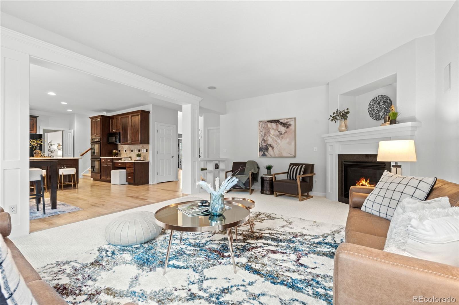 10683 Amesbury Way Highlands Ranch, CO 80126 - Photo 20 of 44 a living room with furniture and a fireplace