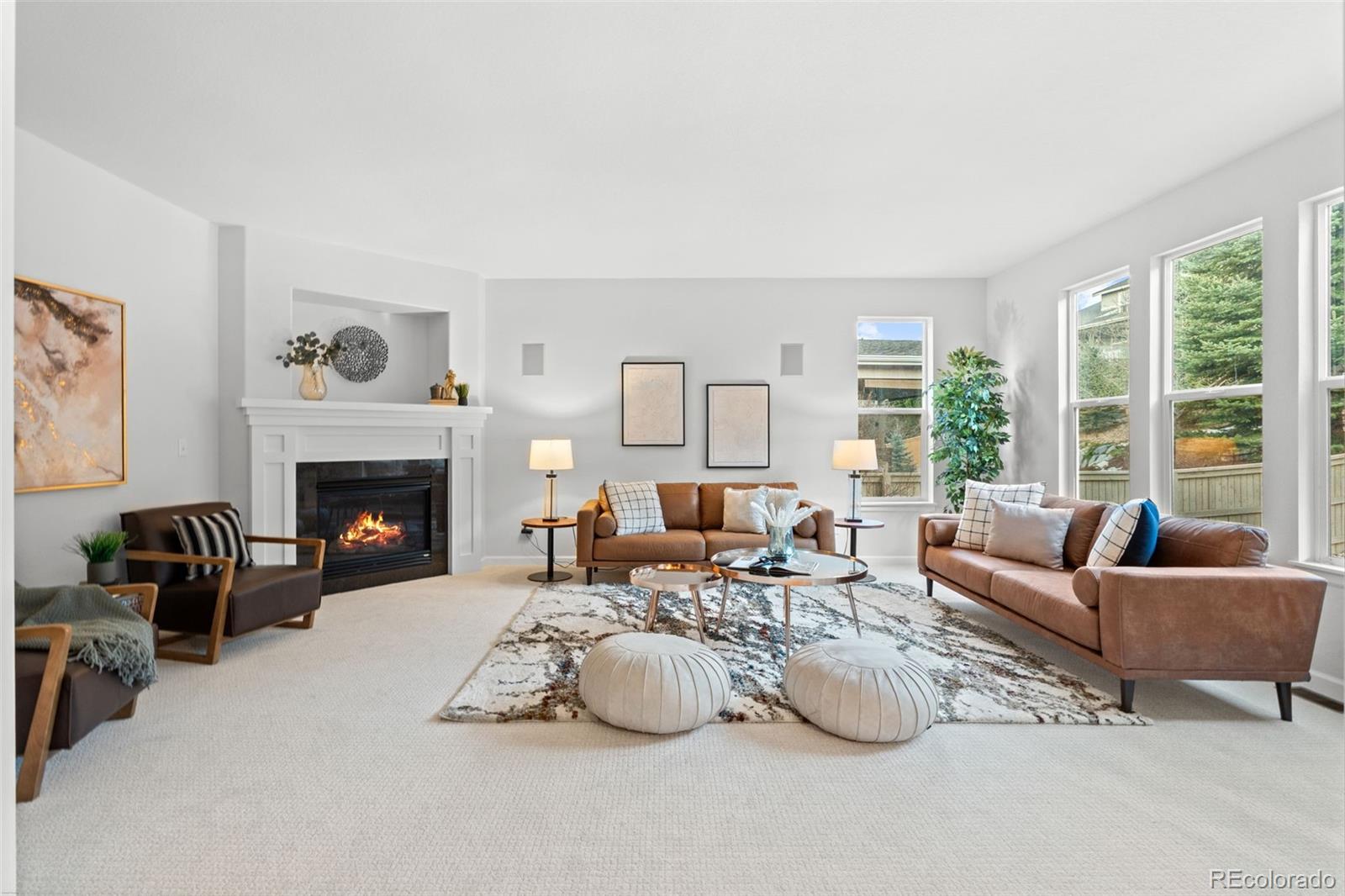 10683 Amesbury Way Highlands Ranch, CO 80126 - Photo 2 of 44 a living room with furniture large window and a fireplace
