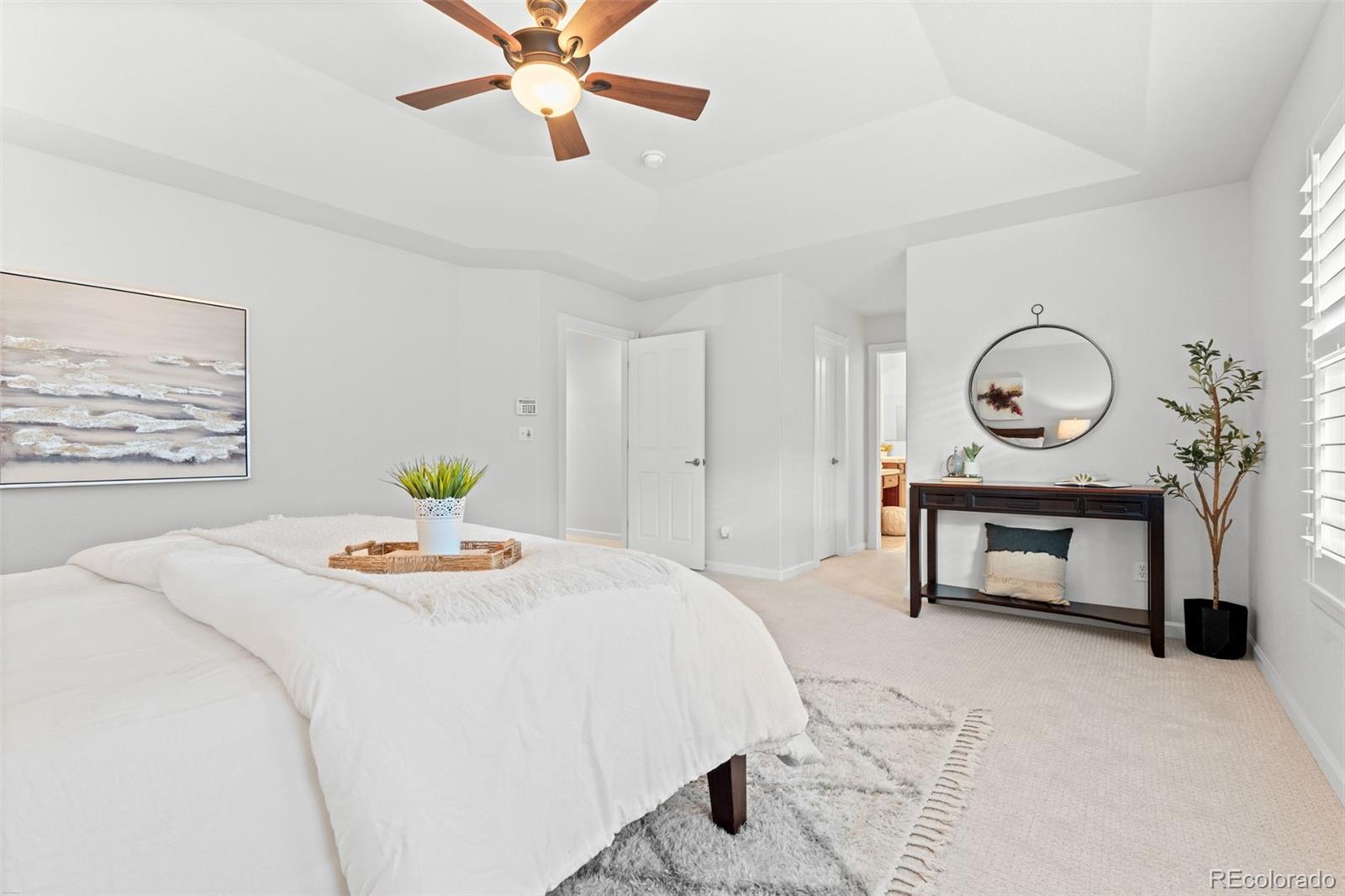 10683 Amesbury Way Highlands Ranch, CO 80126 - Photo 25 of 44 a bedroom with a bed and a table