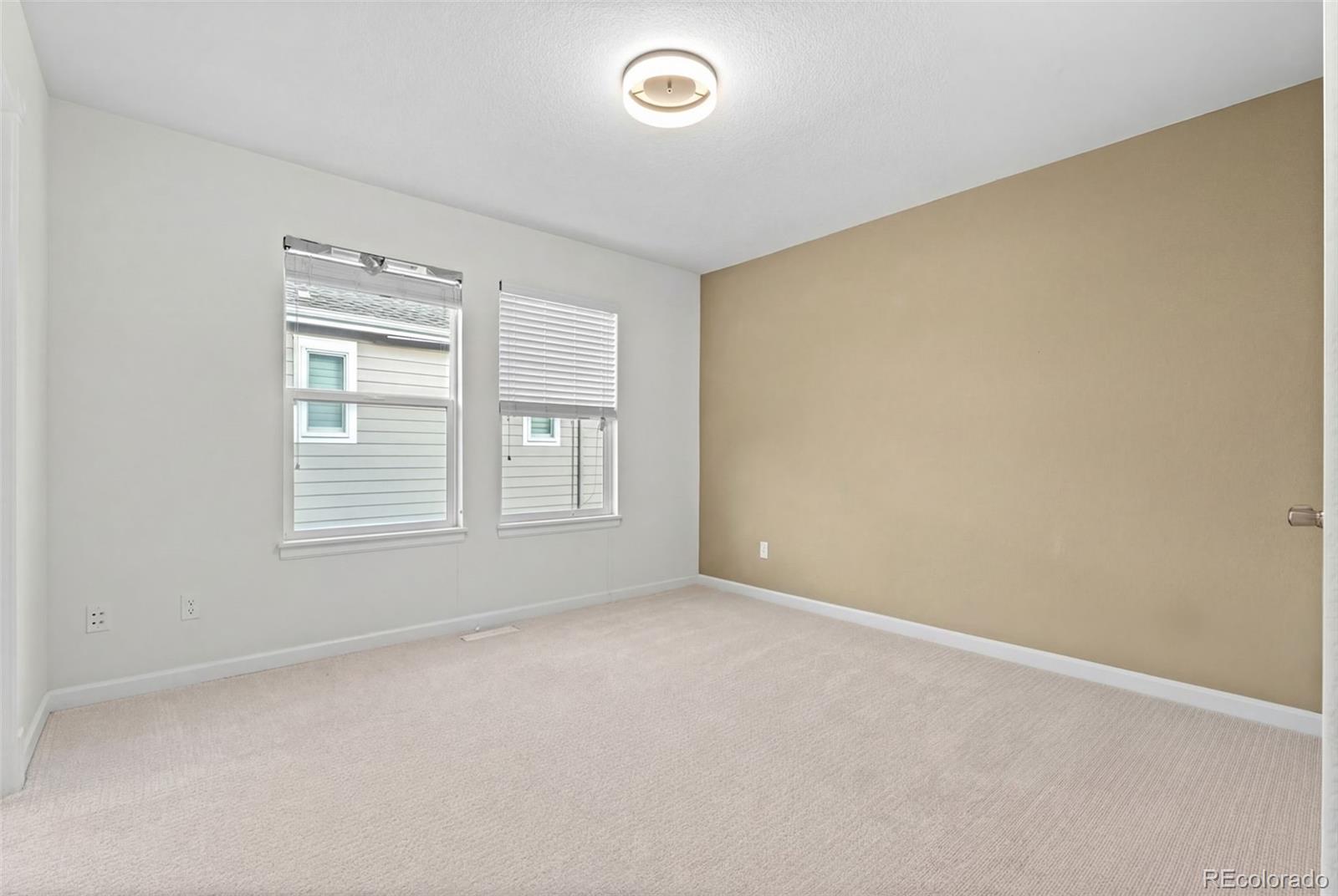 10683 Amesbury Way Highlands Ranch, CO 80126 - Photo 28 of 44 an empty room with windows