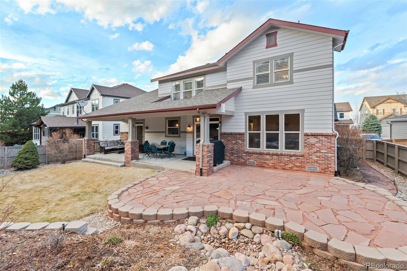 10683 Amesbury Way Highlands Ranch, CO 80126 - Photo 33 of 44 a front view of a house with a yard
