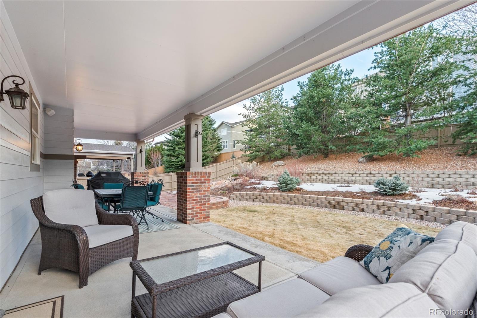 10683 Amesbury Way Highlands Ranch, CO 80126 - Photo 38 of 44 a living room with furniture and a floor to ceiling window