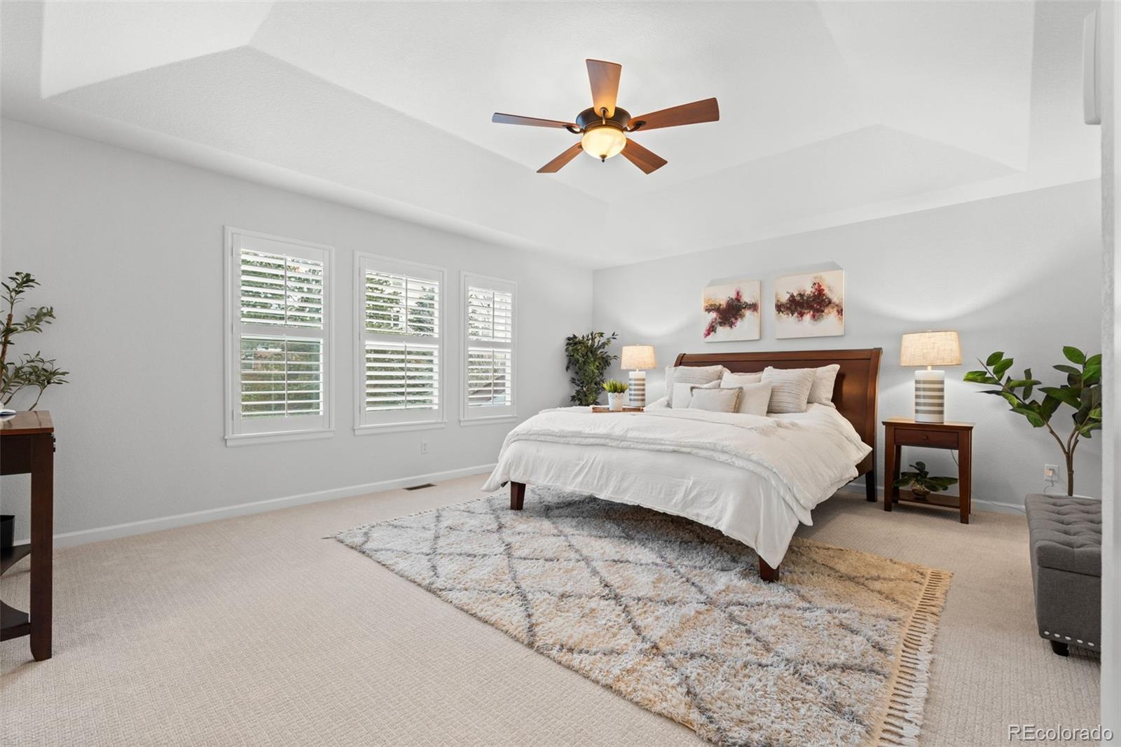 10683 Amesbury Way Highlands Ranch, CO 80126 - Photo 5 of 44 a bedroom with a large bed and a chandelier
