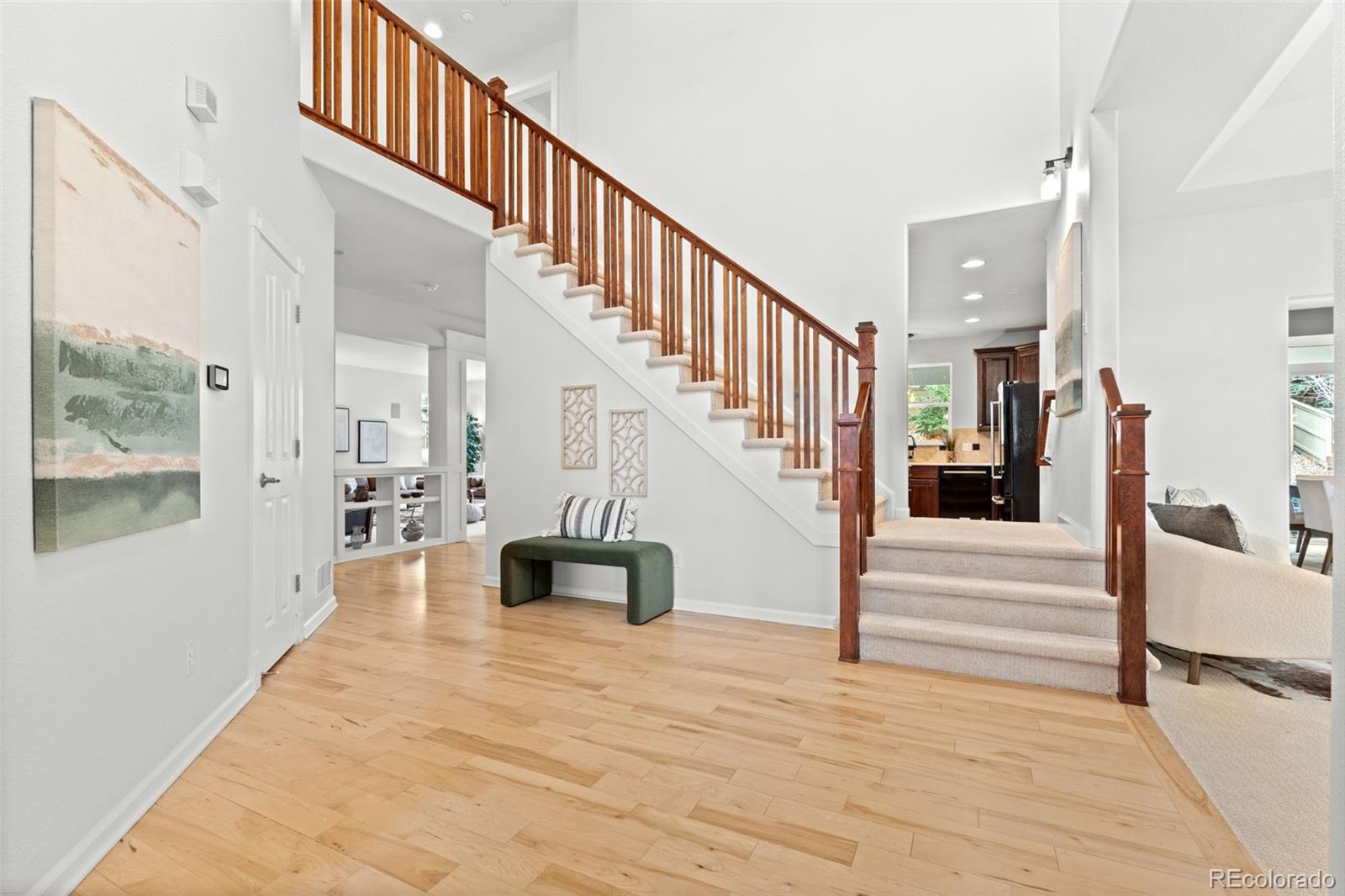 10683 Amesbury Way Highlands Ranch, CO 80126 - Photo 6 of 44 a view of entryway and hall with wooden floor