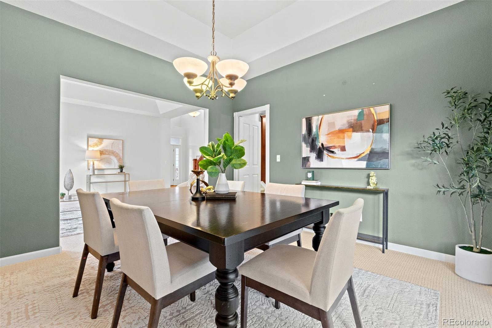 10683 Amesbury Way Highlands Ranch, CO 80126 - Photo 10 of 44 a view of a dining room with furniture a chandelier and wooden floor