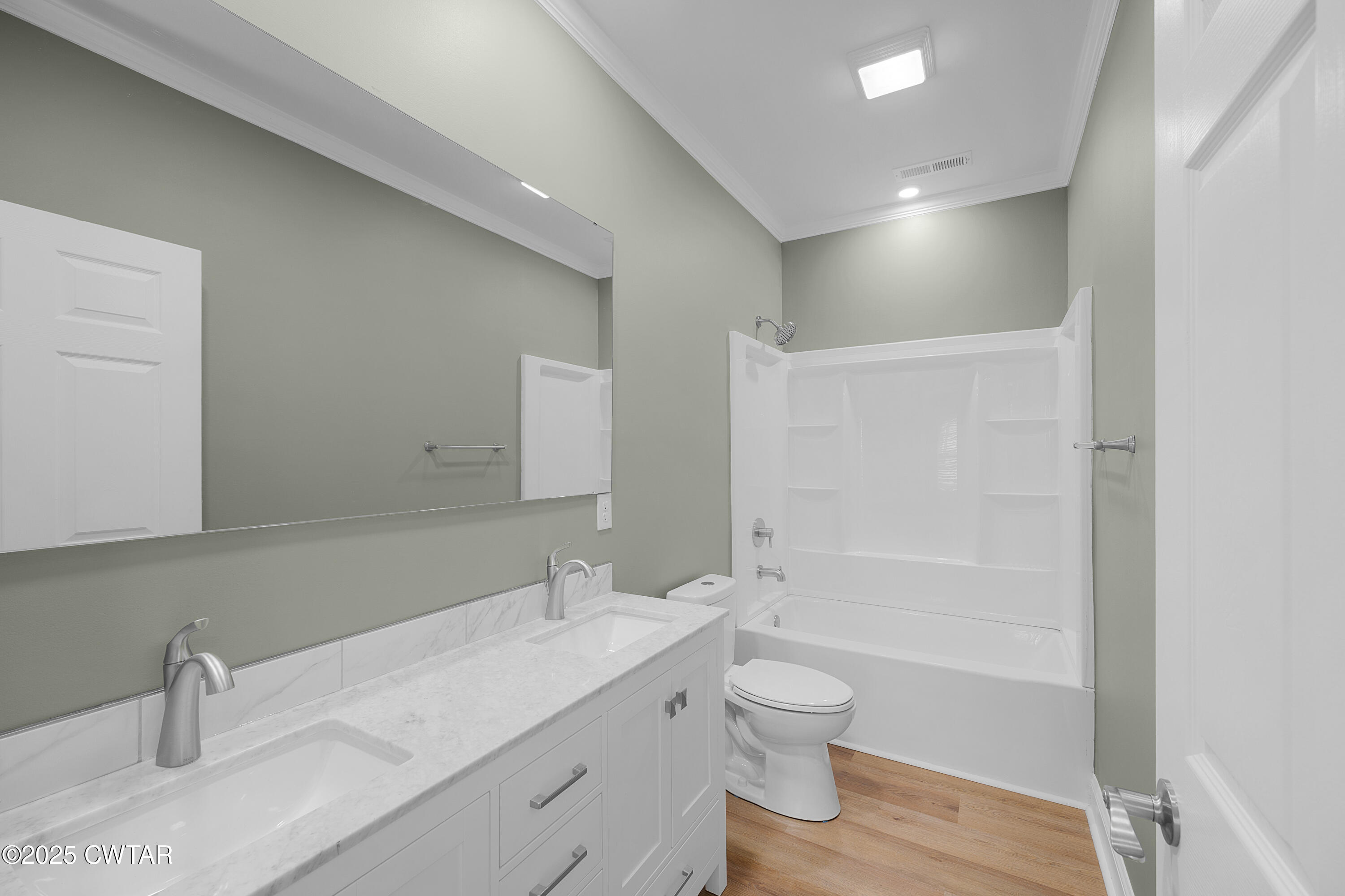 300 West Deaderick Street Jackson, TN 38301 - Photo 14 of 16 a bathroom with a granite countertop sink a toilet and shower