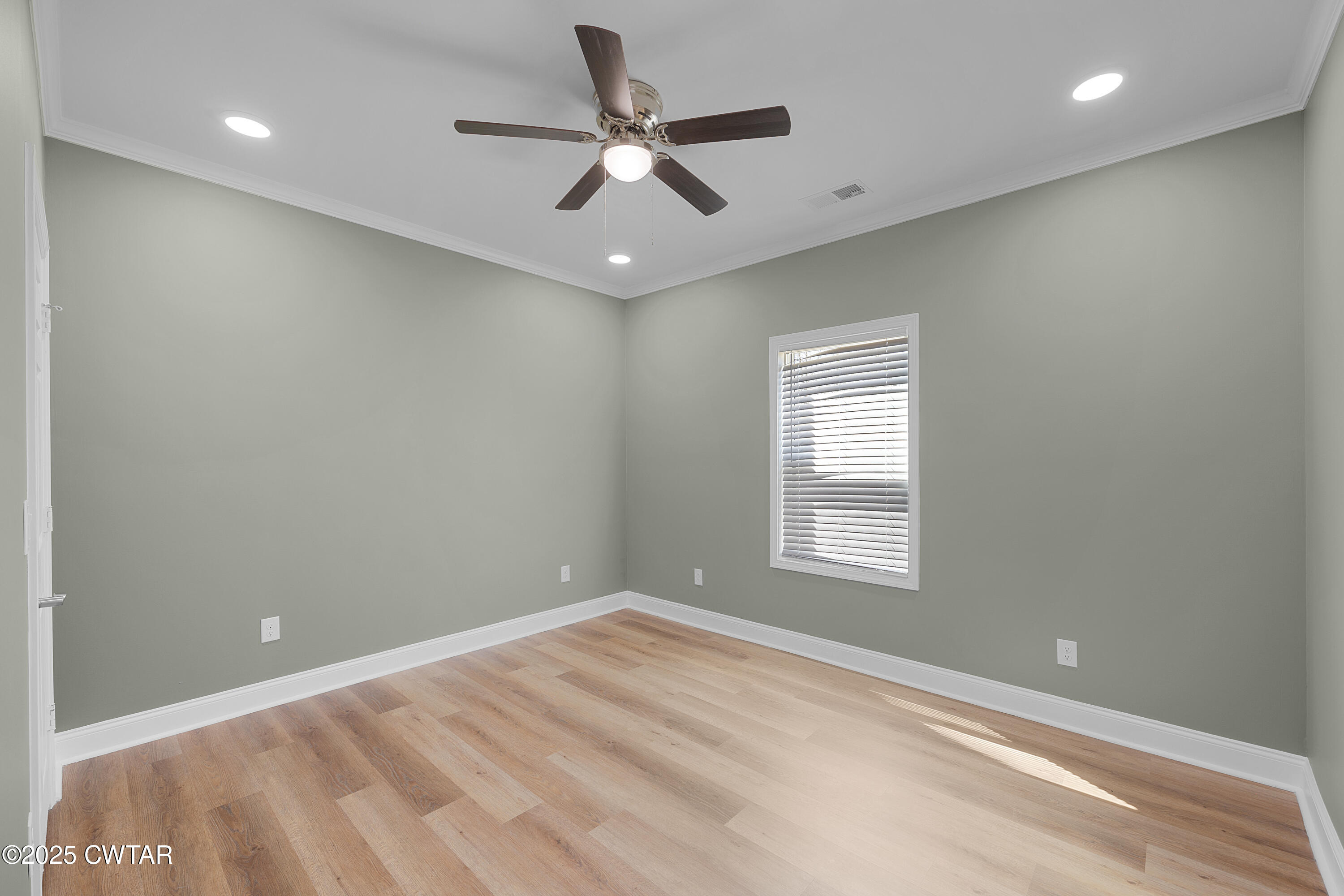 300 West Deaderick Street Jackson, TN 38301 - Photo 16 of 16 an empty room with a window and a ceiling fan