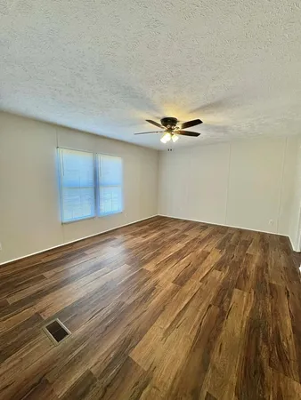 a view of a room with wooden floor