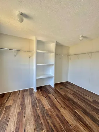 a view of a room with wooden floor