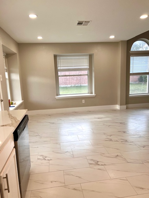 922 Gentry Drive Leander, TX 78641 - Photo 11 of 19 Unfurnished room featuring recessed lighting, light marble finish floors, and plenty of natural light