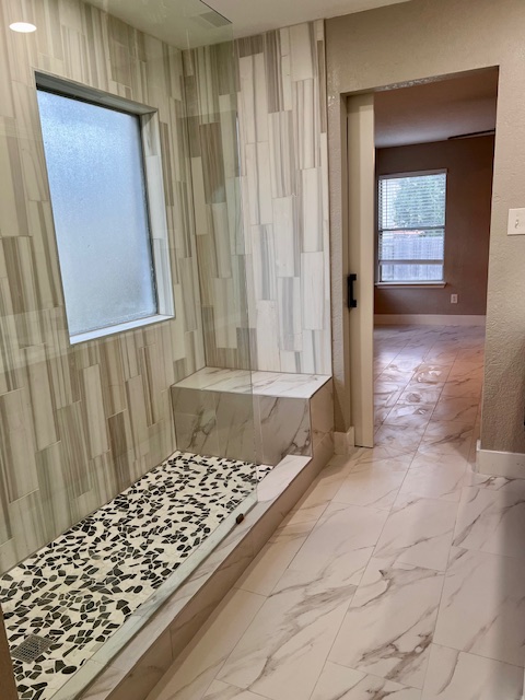 922 Gentry Drive Leander, TX 78641 - Photo 16 of 19 Bathroom with marble finish floors and a marble finish shower