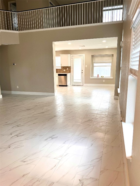 922 Gentry Drive Leander, TX 78641 - Photo 8 of 19 Unfurnished living room with light marble finish floors and a high ceiling