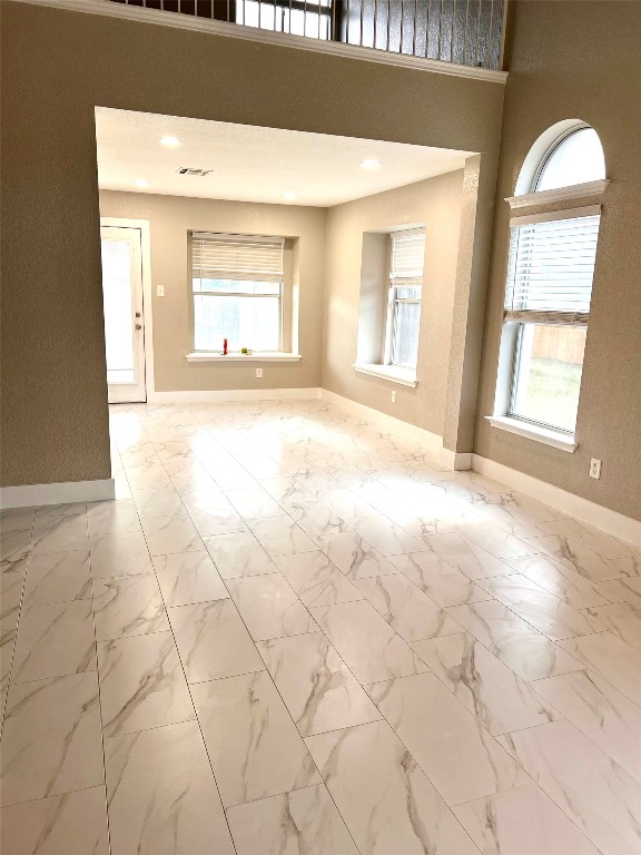 922 Gentry Drive Leander, TX 78641 - Photo 10 of 19 Unfurnished room with light marble finish flooring and healthy amount of natural light