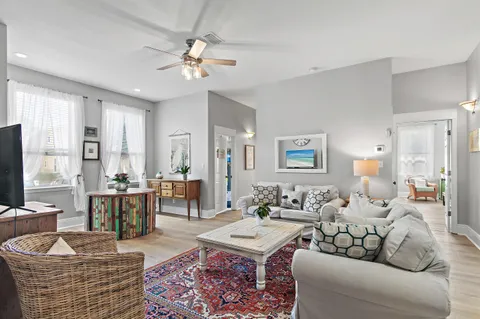 a living room with furniture and wooden floor