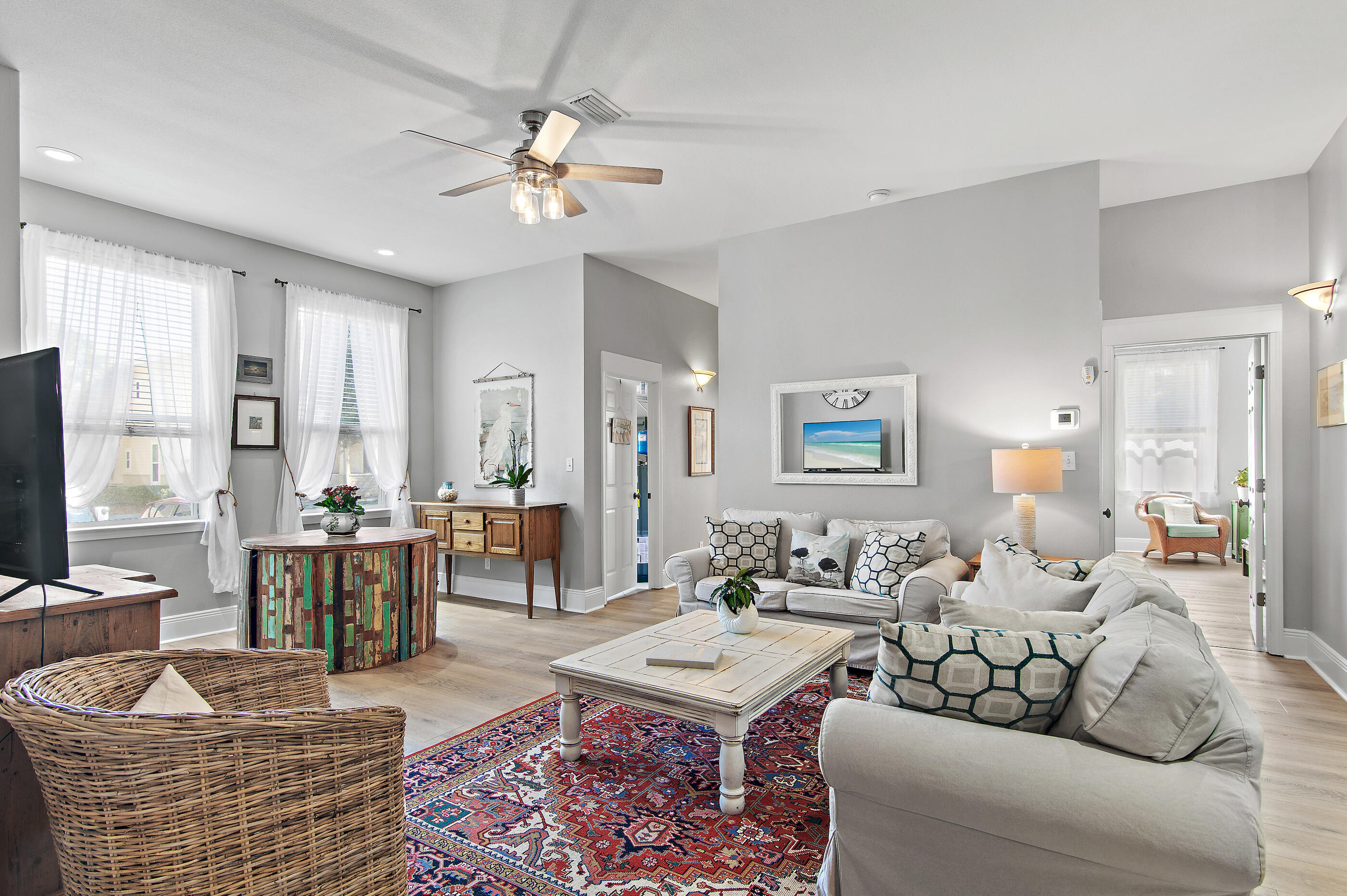a living room with furniture and wooden floor