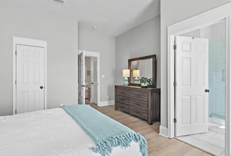 a bedroom with a bed and a mirror