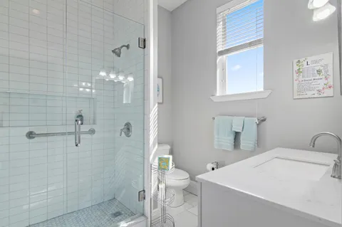 a bathroom with a sink a toilet and shower