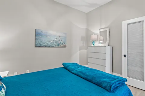 a bedroom with a bed and cabinet