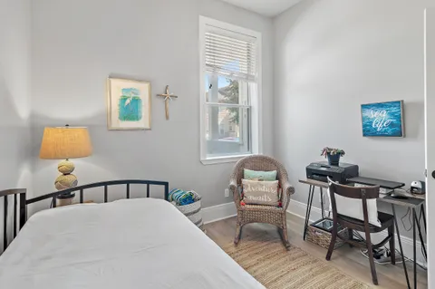 a bedroom with a bed a table and chair