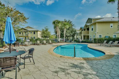 a swimming pool with outdoor seating and yard