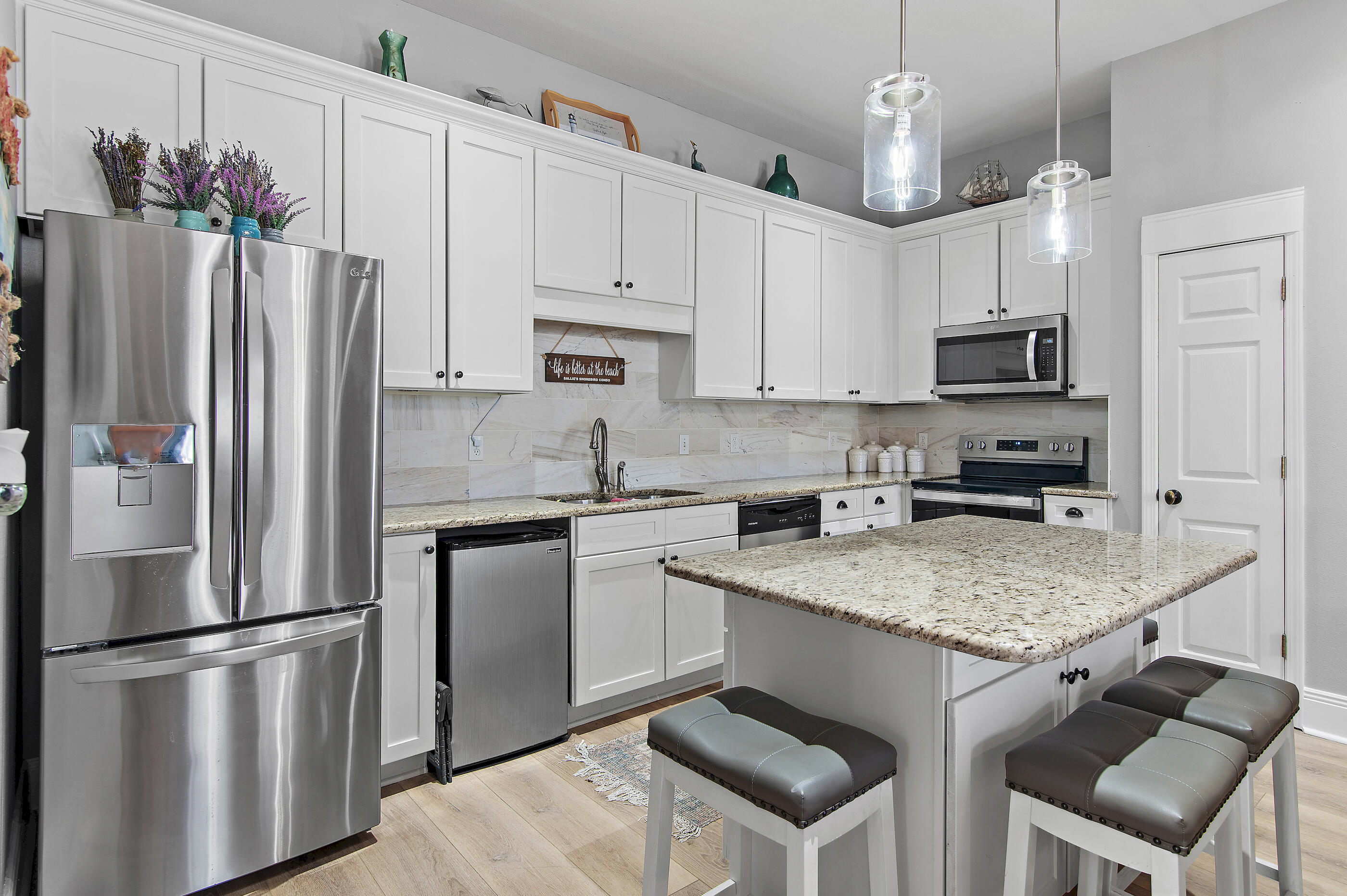 122 Shorebird Drive, Unit 814 Santa Rosa Beach, FL 32459 - Photo 5 of 25 a kitchen with stainless steel appliances granite countertop a refrigerator stove microwave and sink