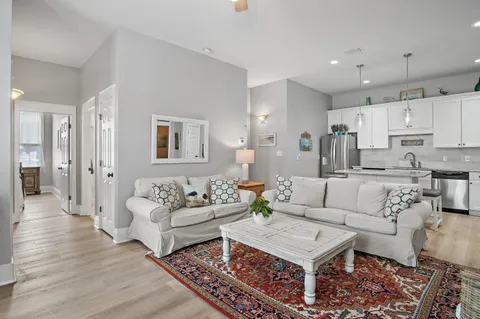 a living room with furniture and a wooden floor